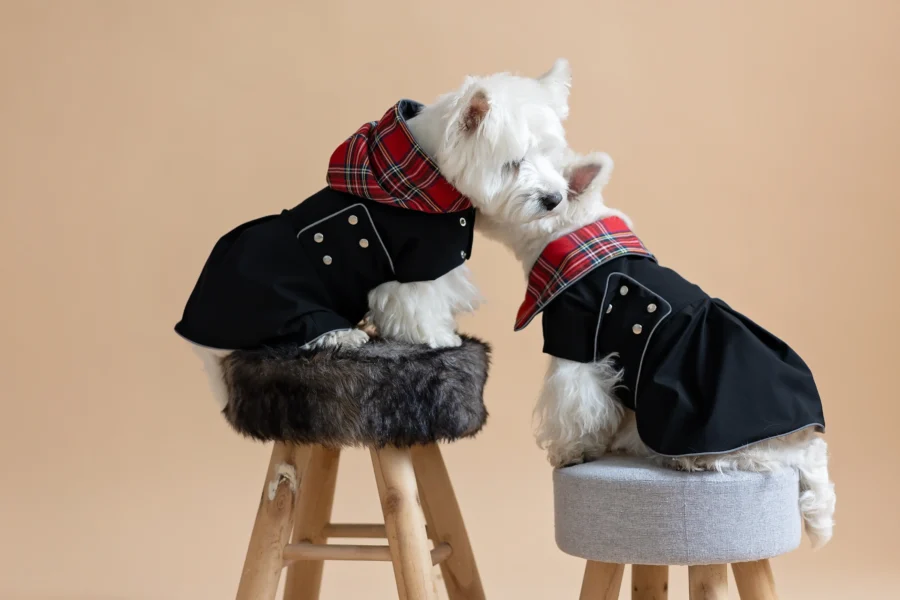 Two white dogs sitting on fur chairs wearing Waterproof Dog Coat-Dress With Plaid Hood or Collar