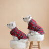 Two white dogs sitting on fur chairs wearing Waterproof Dog Coats With Plaid Hood or Collar