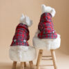 Two white dogs sitting on fur chairs wearing Waterproof Dog Coats With Plaid Hood or Collar